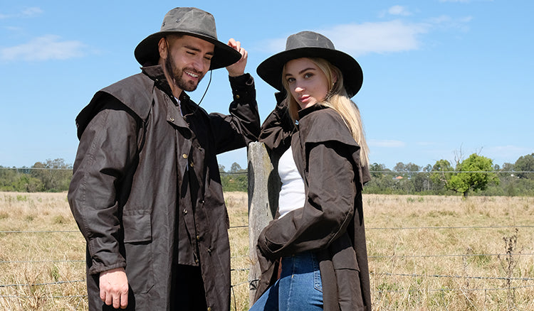 male and female model wearing long coat and black cow boy hat