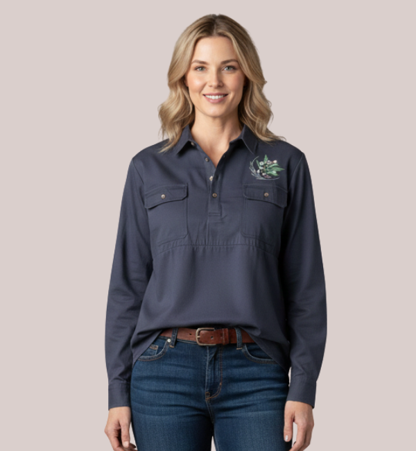 Woman wearing a navy blue long-sleeve customizable maternity and nursing work shirt with a quarter-placket, dual chest pockets, and custom Australian native embroidery.
