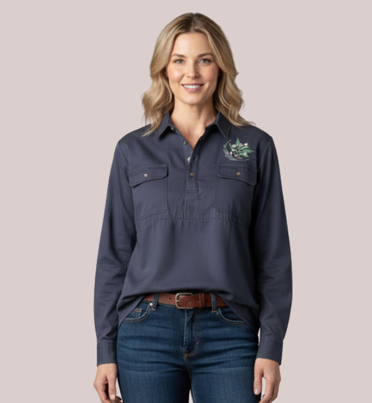 Woman wearing a navy blue long-sleeve customizable maternity and nursing work shirt with a quarter-placket, dual chest pockets, and custom Australian native embroidery.