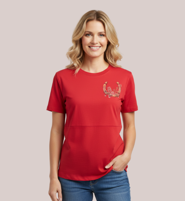 Model wearing a bright red short-sleeve customizable breastfeeding t-shirt featuring a subtle lift-up panel and a decorative custom horseshoe-and-floral embroidery design.